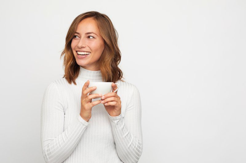 woman smiling and drinking coffee in Richardson