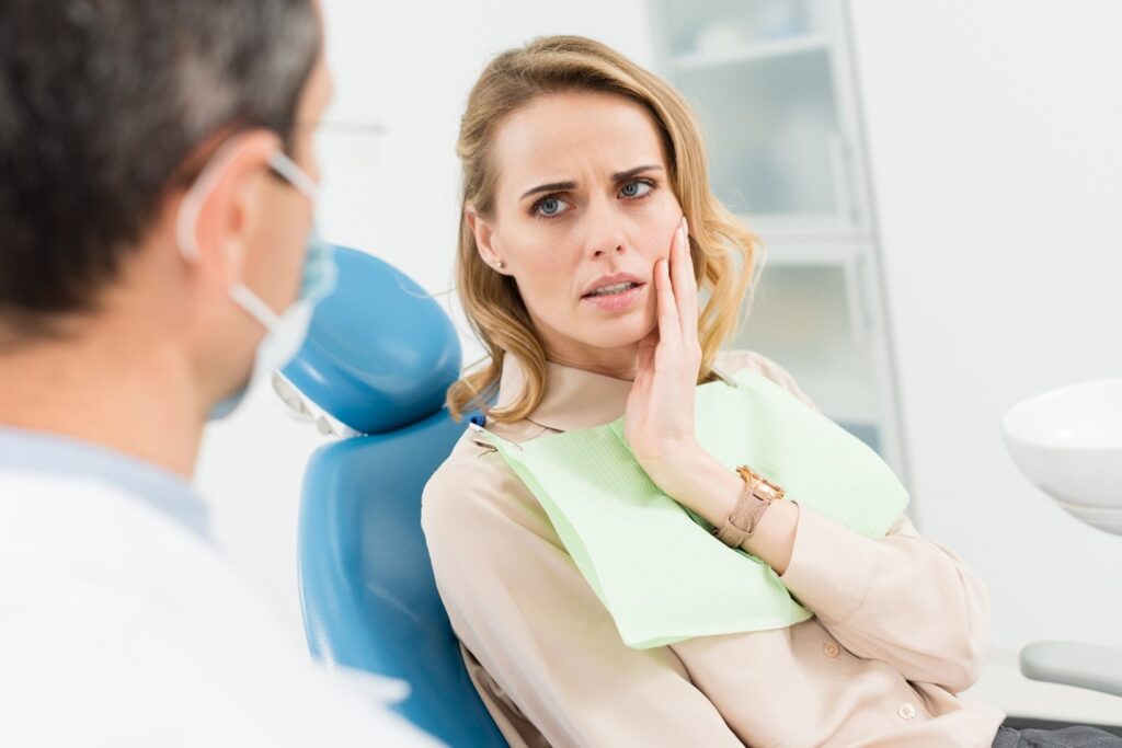 Woman visiting the dentist to have her chipped tooth treated.