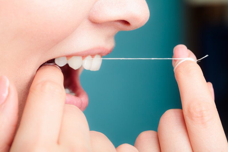 Close-up of someone flossing