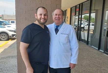 Dr. Ellis Shwarts smiling with Dr. Howard Kessner in front of Shwarts Family Dentistry