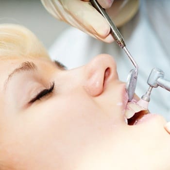 Woman having teeth polished during dental check up and cleaning