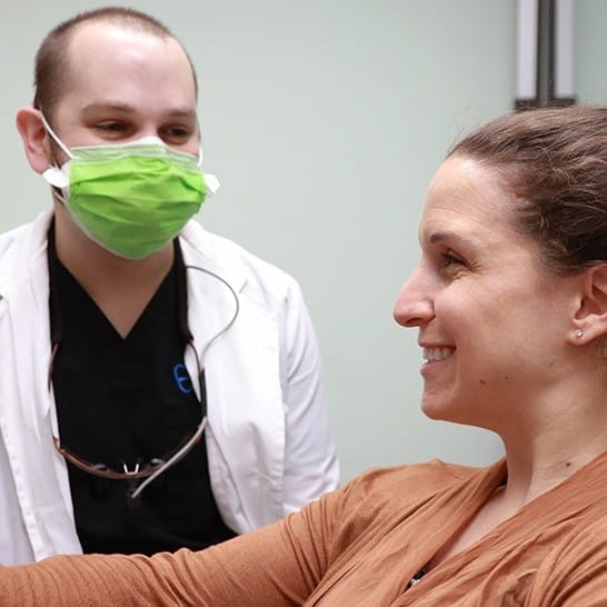 Dr. Ellis Shwarts Cosmetic Dentist talking to smiling patient in Dallas, TX