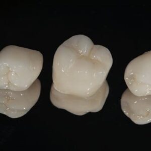 Dental crowns on a black background.