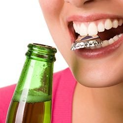 Woman misusing teeth - Emergency Dentistry in Dallas, TX