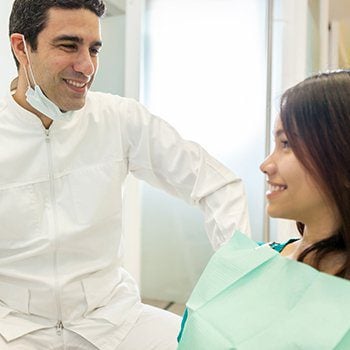 Woman happily consulting with an emergency dentistry dentist