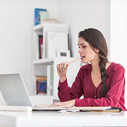Woman searching for dental implant options on the computer