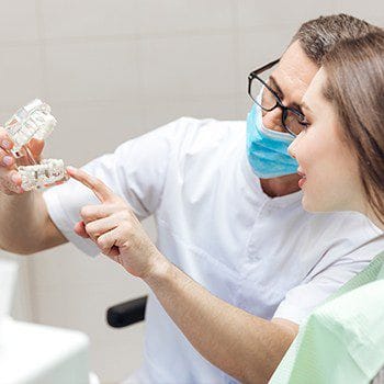 Dentist explaining Dental Implant Process to a Patient
