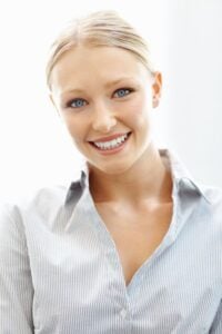 A young blonde woman smiling with porcelain veneers in Dallas.