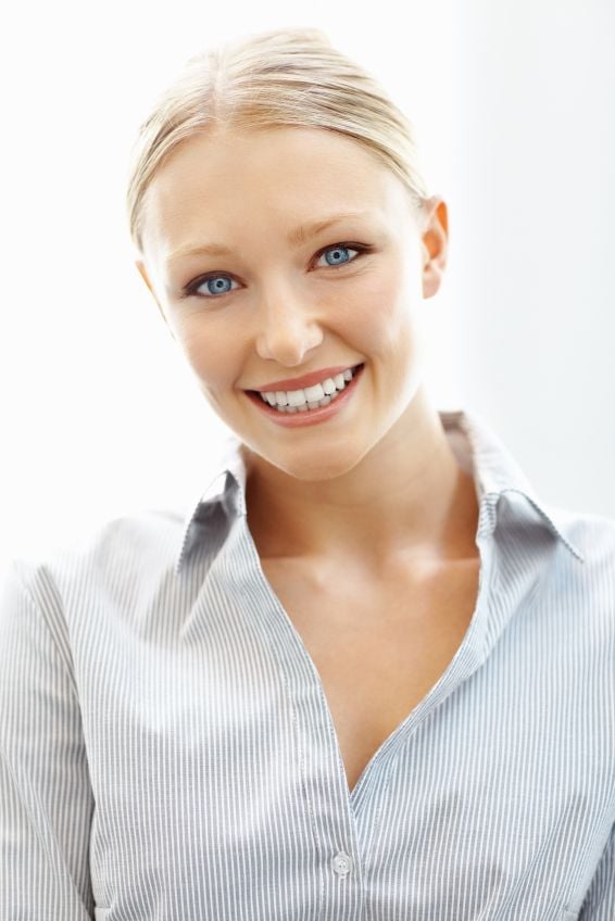 A young blonde woman smiling with porcelain veneers in Dallas.